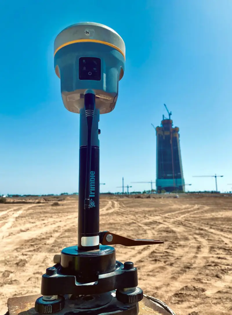 GNSS receiver on a survey pole with Jeddah Tower in the background