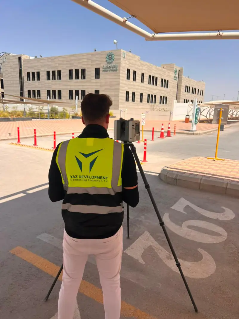 YAZ engineer operating a 3D laser scanner on site